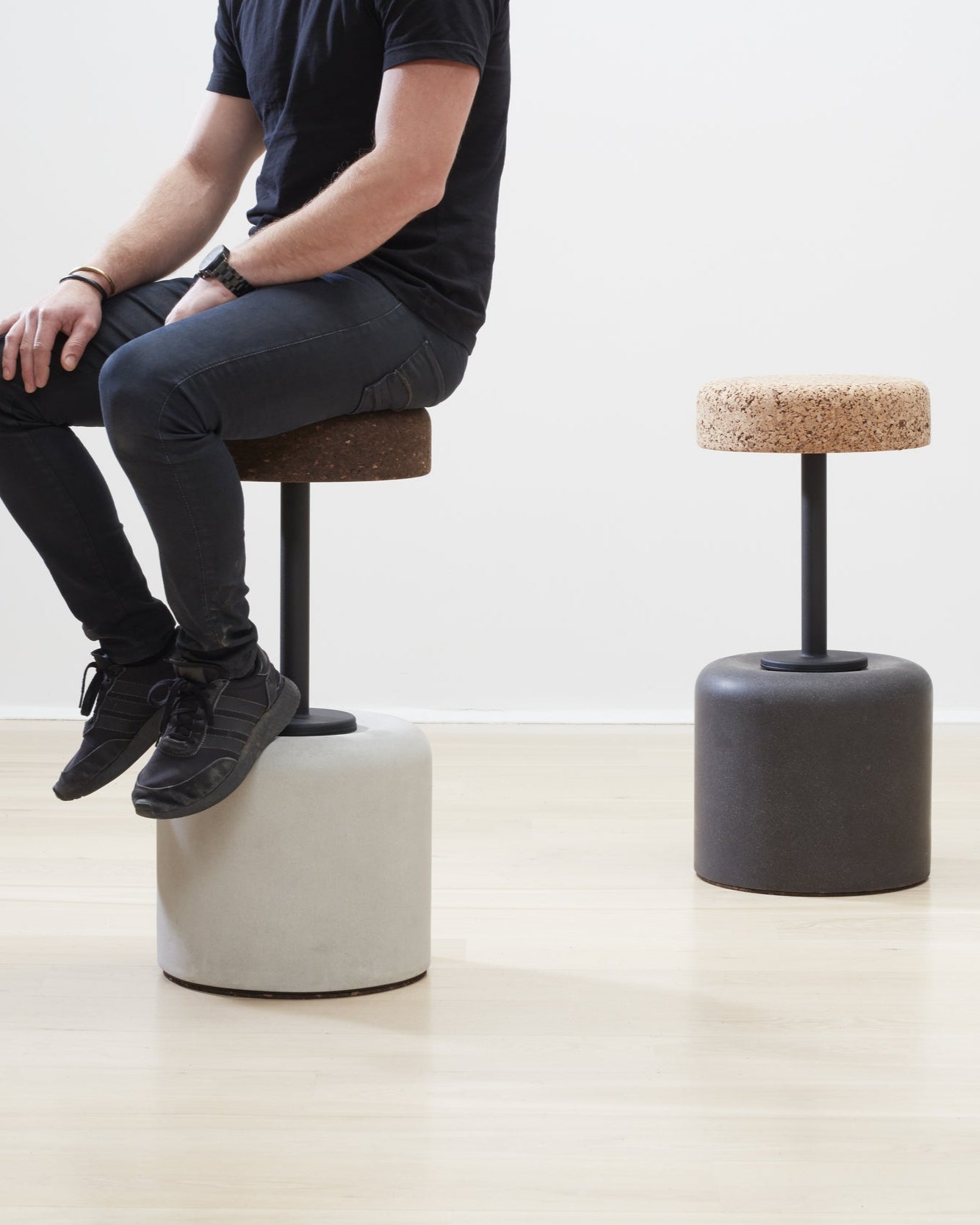 Collection of Kanju's Wiid Swivel Cork and Concrete Barstools charcoal showcasing a variety of finishes: Terrazzo, Natural Grey, and Charcoal Base. This image highlights the diversity and sophistication of the designs, featuring the unique texture of cork combined with durable concrete bases in different hues. Each barstool offers a blend of sustainable materials, swivel functionality, and contemporary style, suitable for modern bars and kitchens.