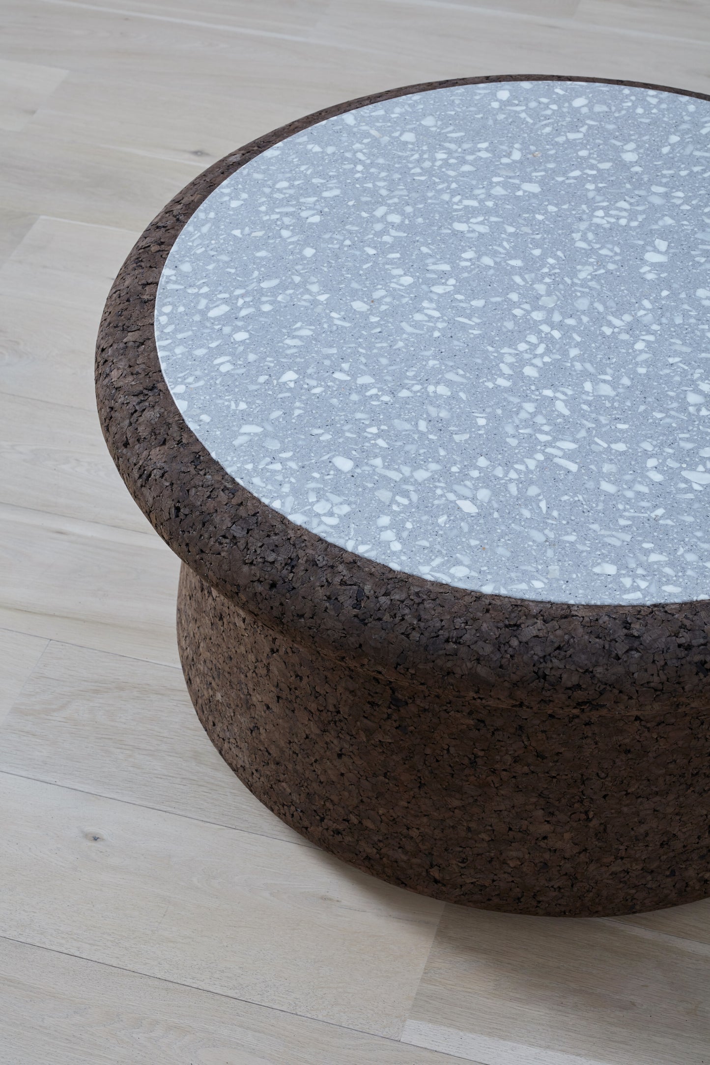 kanju interiors Wiid Design cork coffee table with terrazzo inlay, a masterpiece in luxury home decor. Its design combines timeless elegance with contemporary flair. Perfect for upscale, this coffee table embodies sophisticated style and the fine craftsmanship of African design, appealing to those who appreciate unique, artisanal furniture.