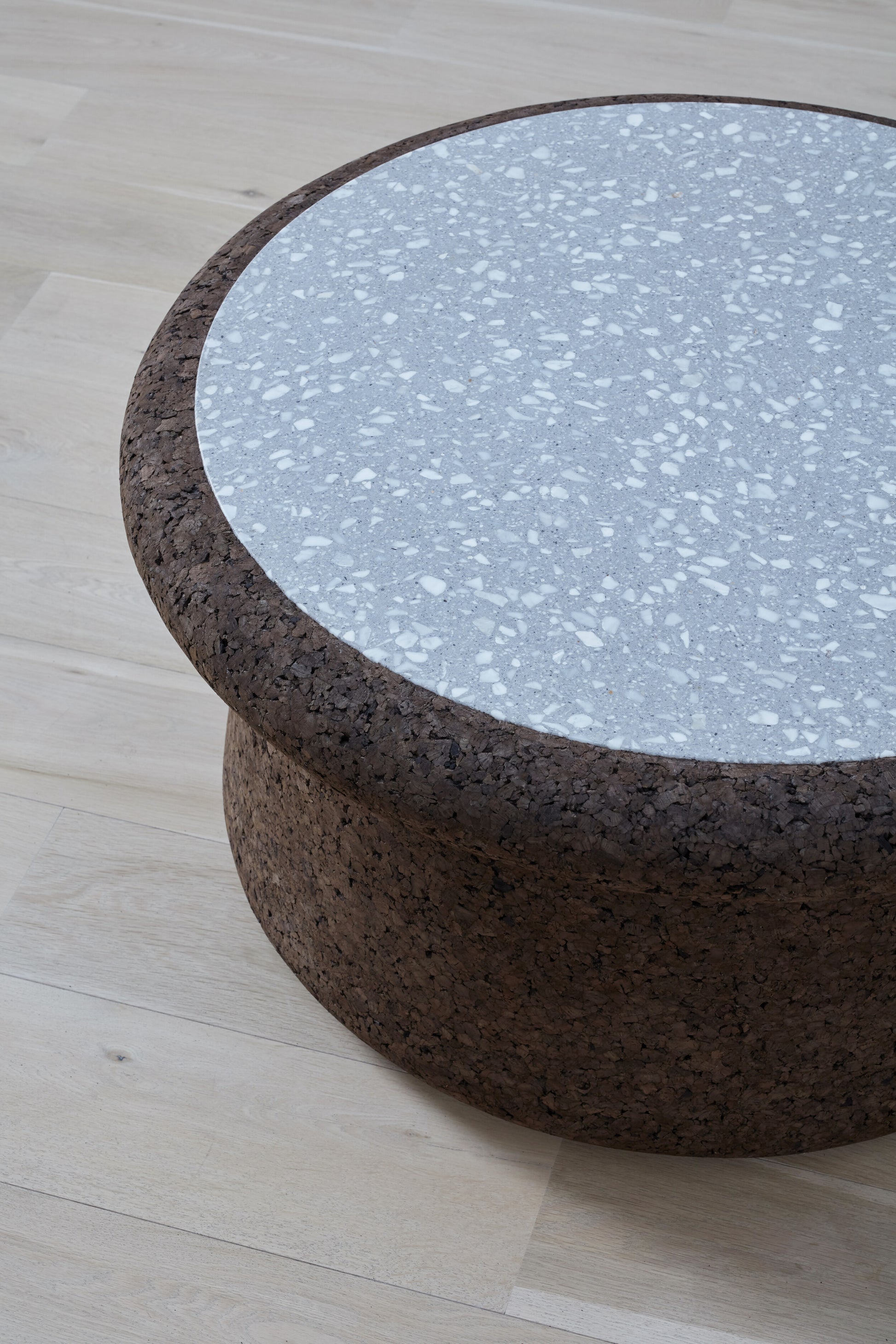 kanju interiors Wiid Design cork coffee table with terrazzo inlay, a masterpiece in luxury home decor. Its design combines timeless elegance with contemporary flair. Perfect for upscale, this coffee table embodies sophisticated style and the fine craftsmanship of African design, appealing to those who appreciate unique, artisanal furniture.