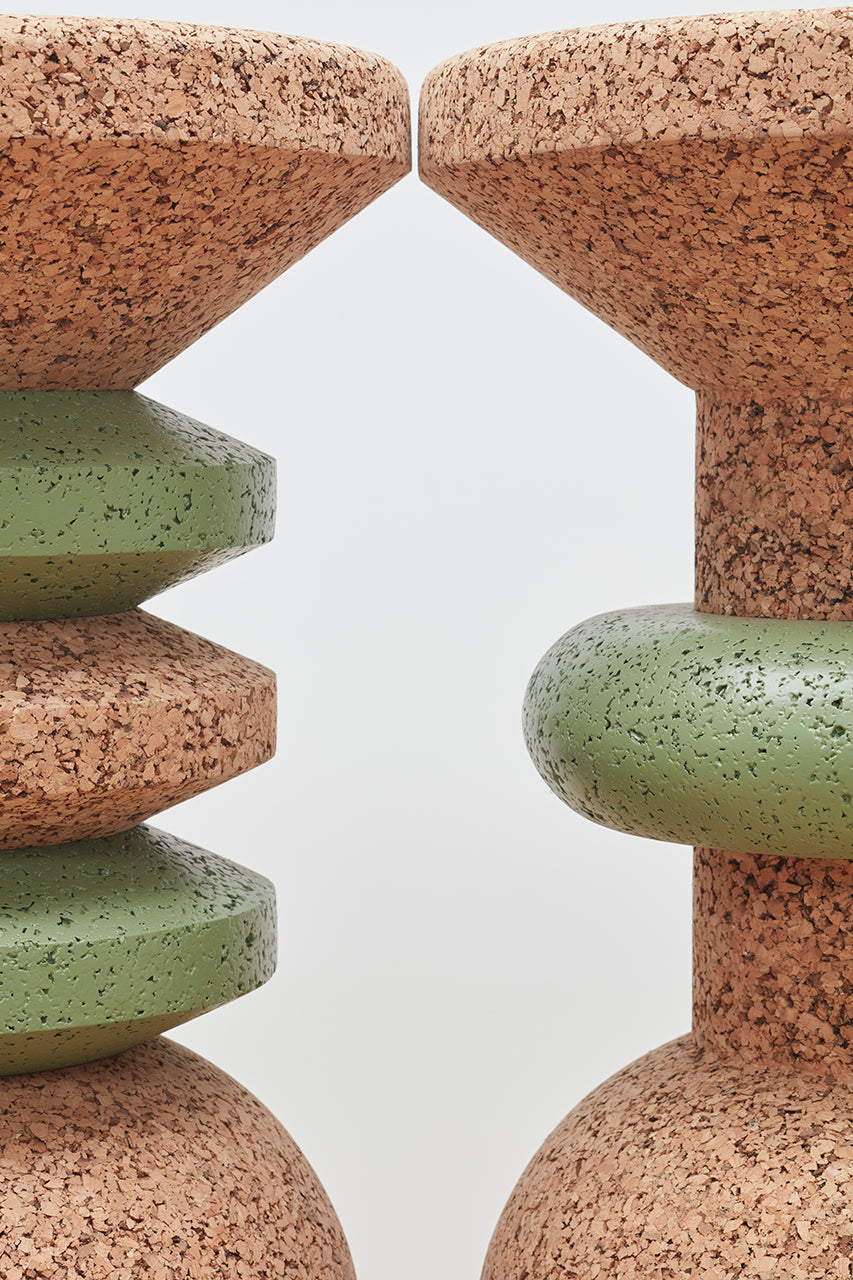 Detail close-up of Kanju's Wiid Green Banded Tall African Cork Side Tables, highlighting both the Stacked and Ringed designs. This image captures the intricate craftsmanship and vibrant green accents against the natural cork, showcasing the tables' unique textures and sustainable elegance. Ideal for adding a touch of artistry and eco-conscious design to any interior space.