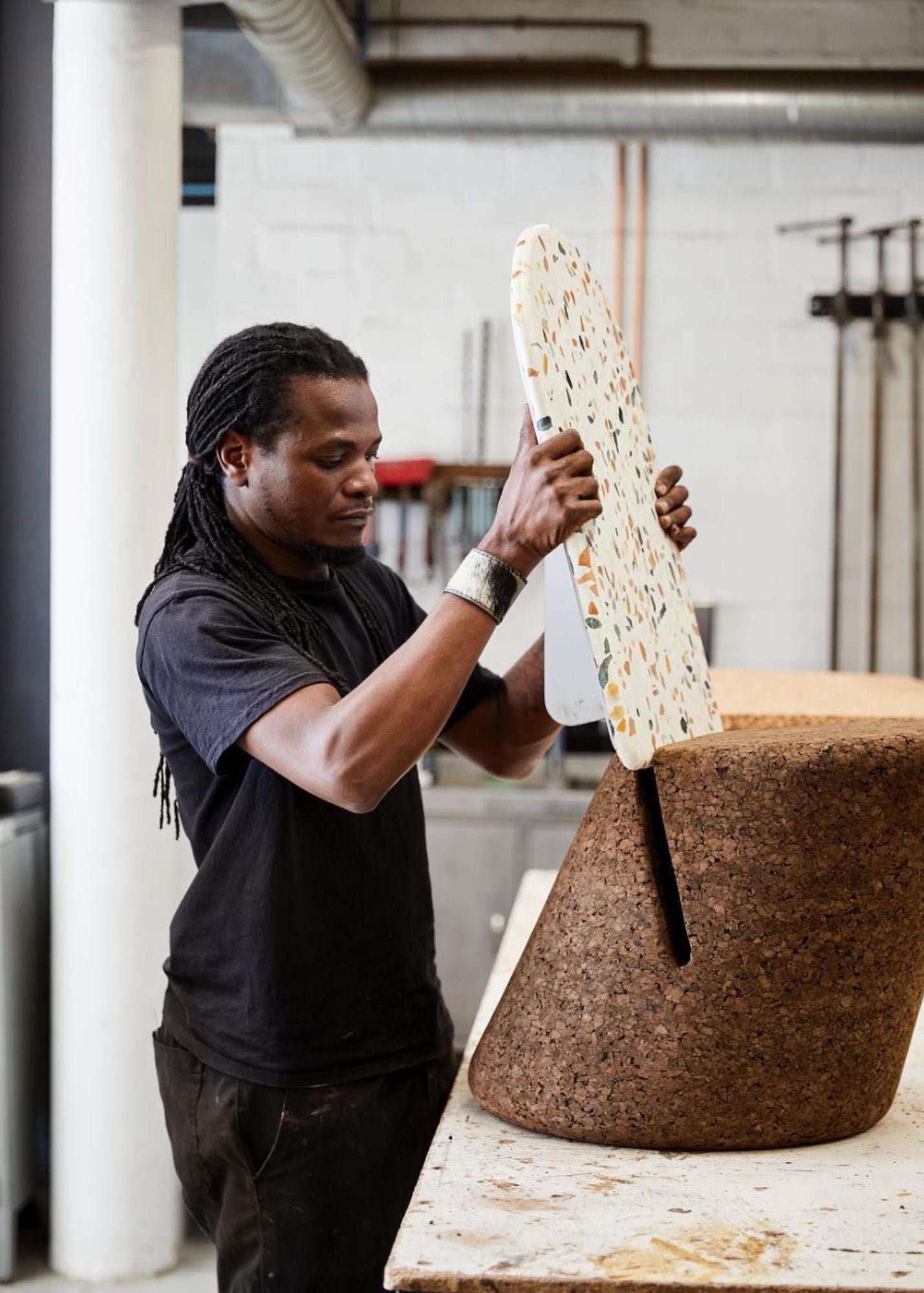 Simple kanju interiors Wiid Design African narrow Cork and terrazzo dining chair in a dark shade of cork, combining contemporary elegance with eco-friendly materials. Offering a stylish and sustainable choice for modern interiors seeking a splash of color and minimalist design.