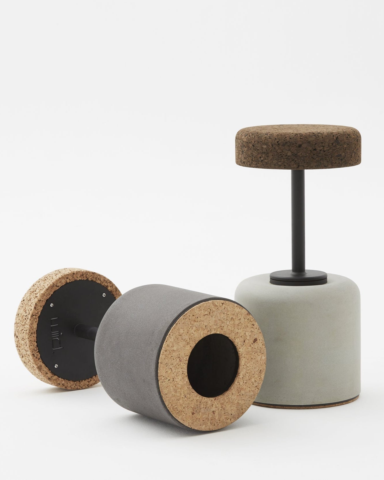 Close-up view of the bottom of Kanju's Wiid Swivel Cork and Concrete Barstool, highlighting the sturdy construction and innovative design. This image showcases the unique combination of natural cork and solid concrete, emphasizing the barstool's balance of eco-friendly materials with functional, contemporary style. The swivel mechanism is subtly integrated, offering both comfort and versatility in upscale bar settings.