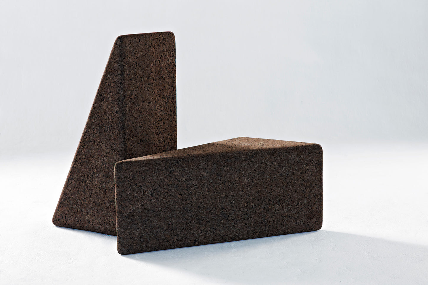 Discover Kanju's Wiid Triangle Cork Tables in rich Dark Cork, a testament to sustainable design and modern aesthetics. These tables showcase the beauty and versatility of cork, crafted into a geometric triangle shape that adds a unique, contemporary touch to any room. Ideal for those who appreciate eco-friendly materials and innovative design in their furniture choices.