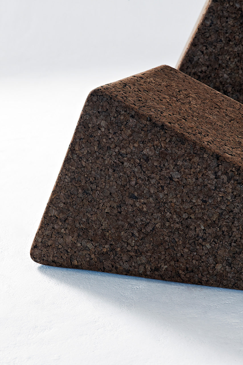 Close-up detail of Kanju's Wiid Triangle Cork Tables in Dark Cork, highlighting the material's textured elegance and the geometric precision of the design. This image captures the depth and richness of the dark cork, emphasizing the tables' sustainable craftsmanship and contemporary aesthetic, perfect for sophisticated, eco-conscious interiors.