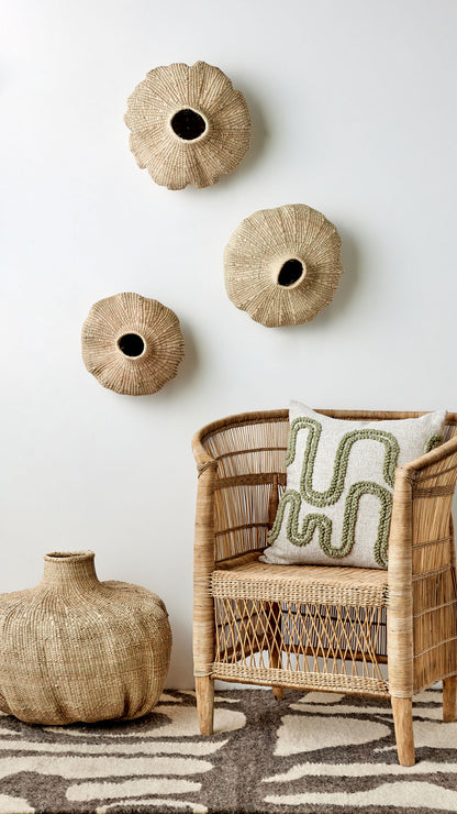 Stunning wall display of Kanju's Garlic Gourds, artfully arranged to create a visually captivating decor piece. Each gourd, with its unique shape and texture, adds a touch of organic elegance to the space, reflecting the beauty of African-inspired design. Perfect for adding a statement of luxury and cultural richness to any room.