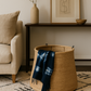 Woven basket with a blue and white patterned blanket in a living room setting.