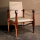 Stylish and comfortable chair with a warm mahogany frame and a cream canvas back and seat, positioned against a muted background that accentuates its clean lines and sophisticated design suitable for luxury interior decor.