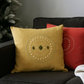 Yellow and red patterned cushions on a dark sofa with a neutral background