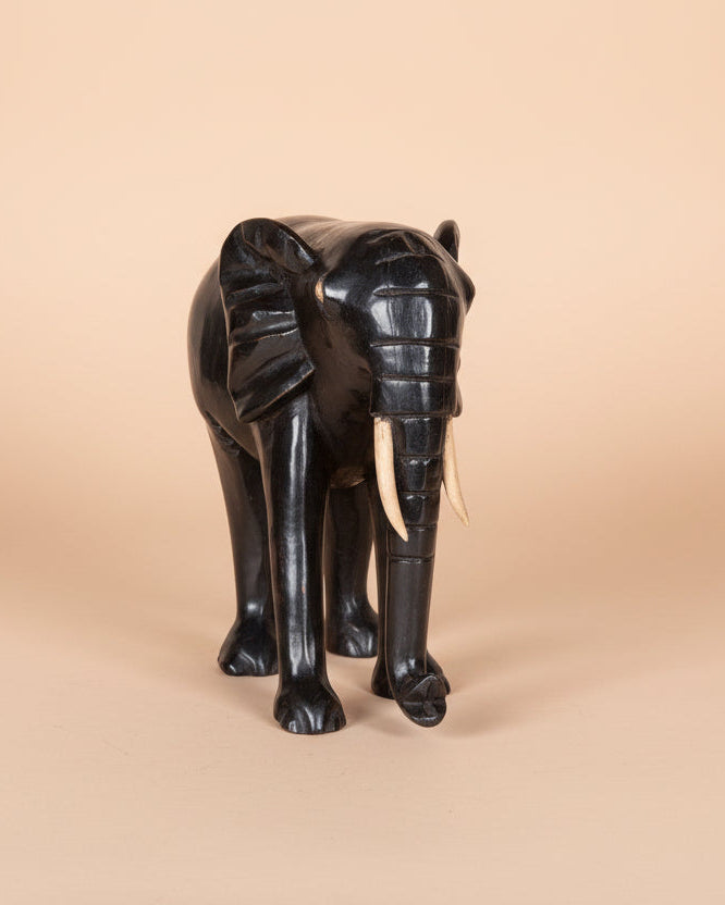Black elephant figurine on a white background