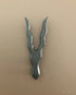 Metallic tool with a unique design on a beige background