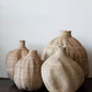 assorted woven african baskets placed in a group on the floor