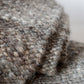 Close-up of textured gray fabric with a blurred background