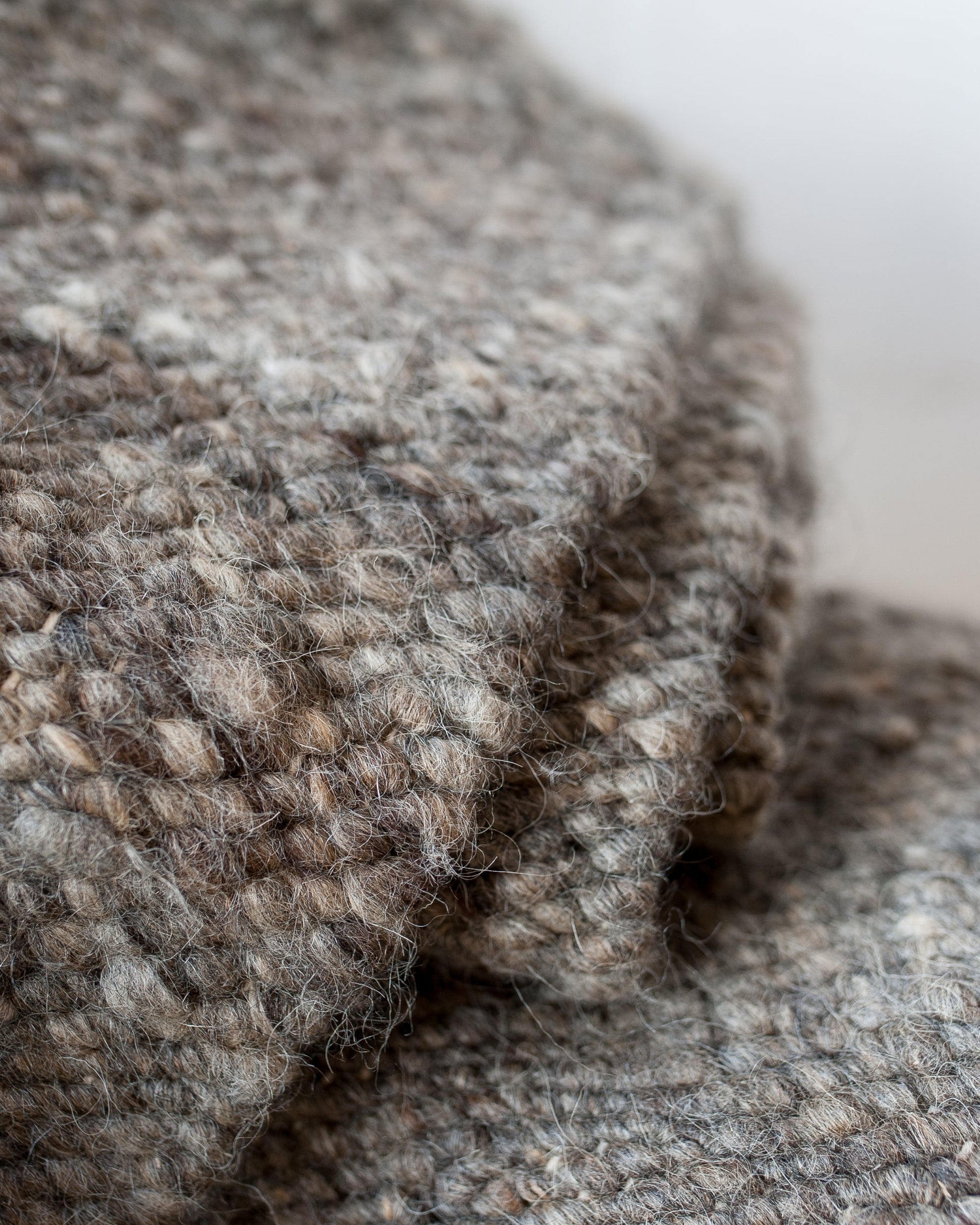 Close-up of textured gray fabric with a blurred background