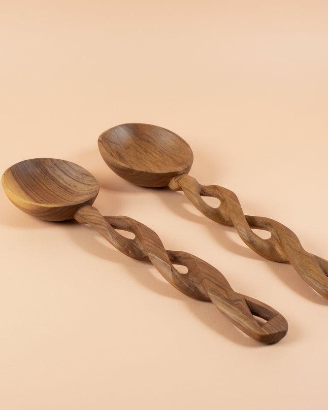 Two wooden ladles with braided handles on a white background