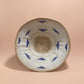 Woven basket with blue patterns on a pink background