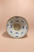 Woven basket with blue patterns on a pink background