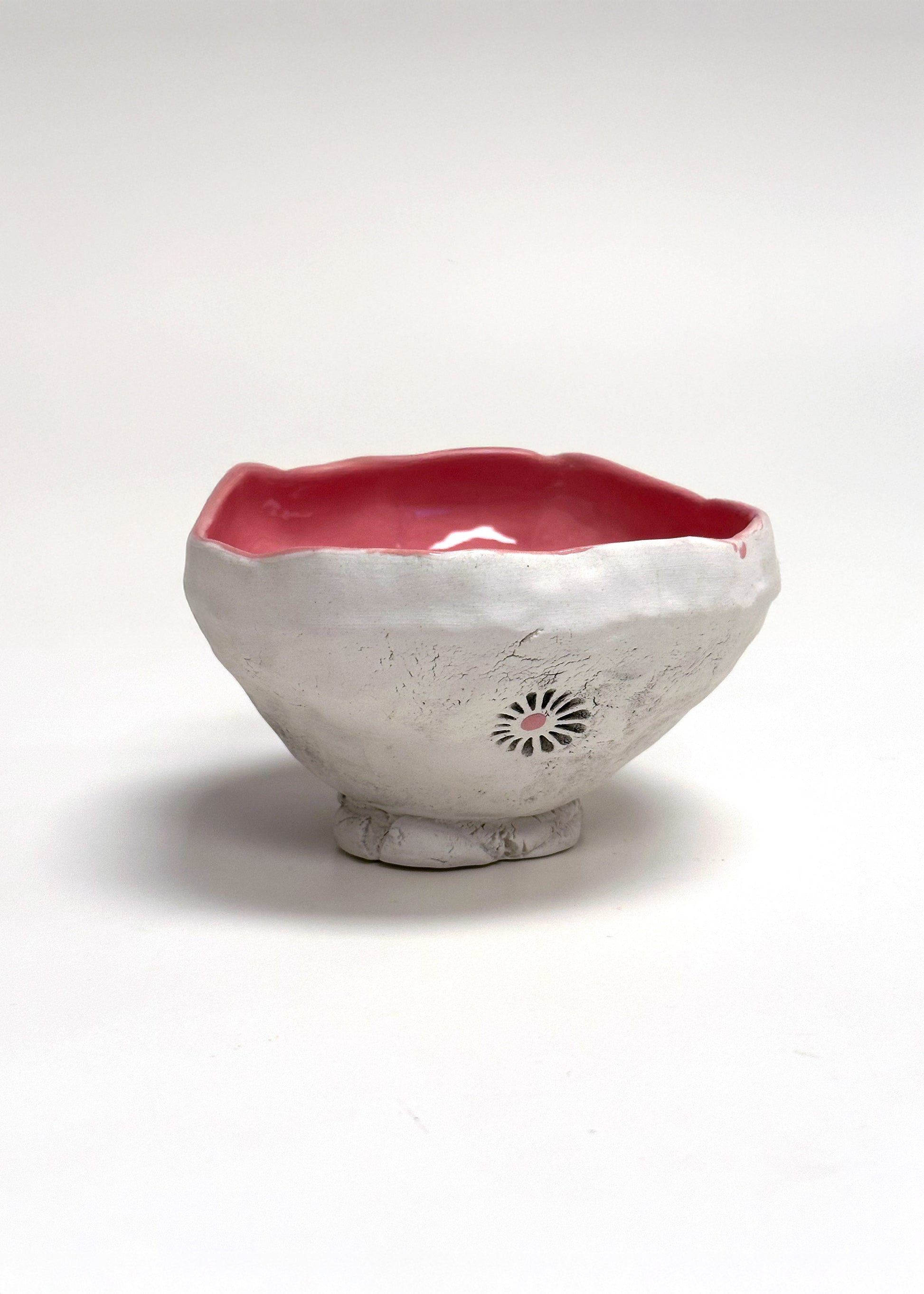 Ceramic bowl with a red interior on a white background