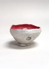 Ceramic bowl with a red interior on a white background
