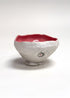 Ceramic bowl with a red interior on a white background