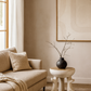 Beige living room with a sofa, side table, and abstract art on the wall.