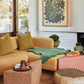 Showcasing the Wiid designs in living room, triangle coffee table, end table, side table. This innovative design by Wiid integrates the earthy texture of dark cork with the solid stability of a concrete and terrazzo base, creating a visually striking and sustainable seating option for contemporary bars and kitchens.