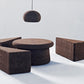 kanju interiors Wiid Design cork dark variety of tables and pendant light, a masterpiece in luxury home decor. Its design combines timeless elegance with contemporary flair. Perfect for upscale, this embodies sophisticated style and the fine craftsmanship of African design, appealing to those who appreciate unique, artisanal furniture.
