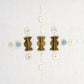 Pair of earrings with gold and bronze designs on a white background