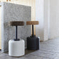 Stylish kitchen setting featuring Kanju's Wiid Swivel Cork and Concrete Barstools: one in Natural Grey Concrete with Dark Cork seat and another in Charcoal with Light Cork. This image illustrates the barstools' perfect fit in a modern kitchen, highlighting their sleek design, swivel functionality, and the elegant contrast of materials and colors. The barstools add a touch of contemporary sophistication and sustainable luxury next to the kitchen counter.