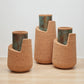 Set of Kanju's Wiid Angled Cork Planters, showcasing a trio of sustainable luxury with a blend of natural cork bodies and verdigris patina interiors, designed in elegant, asymmetrical forms for the discerning and eco-conscious interior decorator.