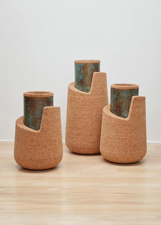 Set of Kanju's Wiid Angled Cork Planters, showcasing a trio of sustainable luxury with a blend of natural cork bodies and verdigris patina interiors, designed in elegant, asymmetrical forms for the discerning and eco-conscious interior decorator.