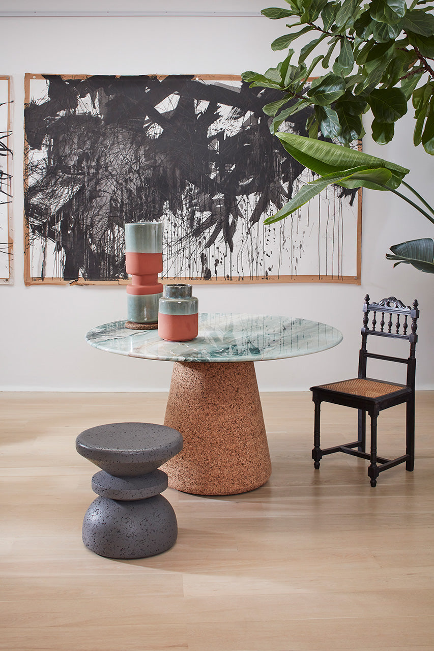 Elegant Kanju Wiid Design Painted African Cork Stool in a sophisticated grey finish, blending traditional craftsmanship with modern design. This eco-friendly seating option offers both style and sustainability, perfect for adding a touch of minimalist elegance to any interior space.