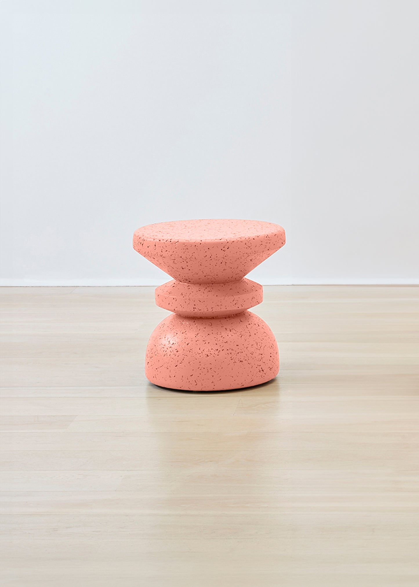 Eye-catching Kanju Wiid Painted African Stacked Cork Stool in a lively coral color, showcasing innovative design and eco-sustainability. This artfully stacked stool combines vibrant appeal with the textured warmth of cork, offering a statement piece that brings both style and environmental consciousness to any interior.