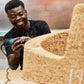 Behind-the-scenes look at the creation of Kanju's Wiid Angled Cork Planter, capturing the meticulous craftsmanship of skilled artisans. This image reveals the sustainable cork being shaped into the planter's distinctive angled design, highlighting the blend of traditional techniques and modern innovation unique to African luxury home decor.