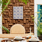 Luxurious Kanju Interiors dining space, adorned with Wiid Design Angular Cork Wall Panels and an exquisite Moroccan-inspired tile inlay, complemented by verdant plant accents and sophisticated table settings on a premium walnut table