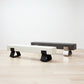 kanju interiors Wiid Design concrete bench in charcoal or white, powder matte black stainless steel legs or polished steel legs, a masterpiece in luxury home decor. Its design combines timeless elegance with contemporary artistic flair. Perfect for upscale Living rooms, dining room or bedrooms, this table embodies sophisticated style and the fine craftsmanship of African design, appealing to those who appreciate unique, artisanal furniture.