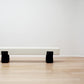 kanju interiors Wiid Design concrete benches, powder matte black, a masterpiece in luxury home decor. Its design combines timeless elegance with contemporary artistic flair. Perfect for upscale Living rooms, dining room or bedrooms, this table embodies sophisticated style and the fine craftsmanship of African design, appealing to those who appreciate unique, artisanal furniture.