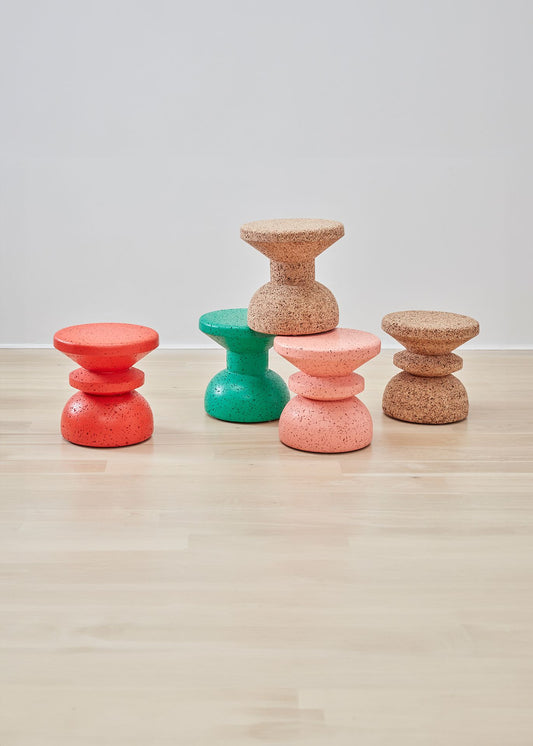 Dynamic Kanju Wiid African Painted Cork Stool assortment featuring Slim and Stacked styles in vibrant red, blue, natural light cork, and playful pink. This diverse selection highlights the beauty of eco-friendly cork, painted to perfection, merging contemporary design with traditional craftsmanship. Perfect for adding a distinctive touch of color, texture, and sustainable design to any space.