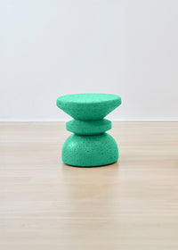 Striking Kanju Wiid African Stacked Cork Stool painted in a serene teal, blending innovative design with eco-sustainability. This visually appealing stool layers cork for a textured, contemporary look, ideal for adding a splash of color and artisanal charm to modern spaces.