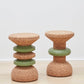 Image showcasing both designs of Kanju's Wiid Green Banded Tall African Cork Side Tables – the sophisticated Stacked and the elegant Ringed models. Each table features a distinctive green band that beautifully contrasts with the natural cork texture, demonstrating the versatility and artistry of sustainable design. Perfect for adding a unique, eco-friendly touch to any interior space.