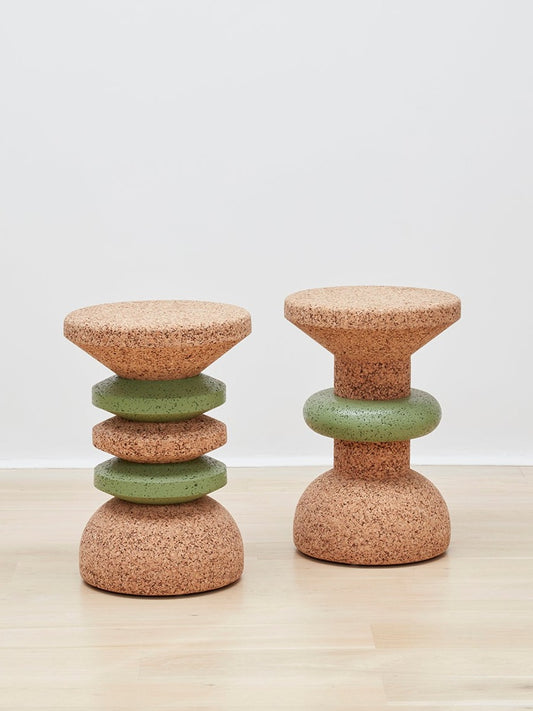 Image showcasing both designs of Kanju's Wiid Green Banded Tall African Cork Side Tables – the sophisticated Stacked and the elegant Ringed models. Each table features a distinctive green band that beautifully contrasts with the natural cork texture, demonstrating the versatility and artistry of sustainable design. Perfect for adding a unique, eco-friendly touch to any interior space.