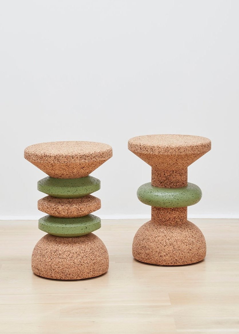 Image showcasing both designs of Kanju's Wiid Green Banded Tall African Cork Side Tables – the sophisticated Stacked and the elegant Ringed models. Each table features a distinctive green band that beautifully contrasts with the natural cork texture, demonstrating the versatility and artistry of sustainable design. Perfect for adding a unique, eco-friendly touch to any interior space.