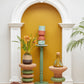 Artfully styled image featuring Kanju's Wiid Green Banded Tall African Cork Side Tables in both Stacked and Ringed designs. The photograph highlights the elegant interplay of natural cork texture with sophisticated green bands, set in a curated interior space that underscores their modern, sustainable beauty. These side tables exemplify luxury and eco-conscious design, perfectly blending with contemporary decor.