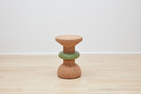 Showcase of Kanju's Wiid Green Banded Tall African Cork Side Table with a unique ringed design. This piece combines the natural texture of cork with a distinctive green band, creating a stylish and sustainable addition to any interior space. Perfect for those who appreciate eco-friendly luxury and innovative, artisan-crafted furniture.