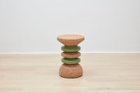 Elegant Wiid Green Banded Tall African Cork Side Table featuring a stacked design, presented by Kanju. This artful piece marries the warmth of cork with vibrant green accents, creating a visually striking yet functional addition to any room. Its stacked silhouette exemplifies modern craftsmanship, perfect for those valuing unique, sustainable decor.