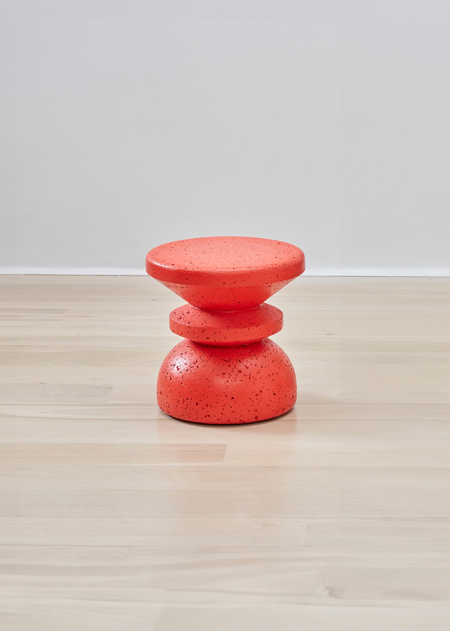 Bold Kanju Wiid Painted African Stacked Cork Stool in a vibrant red, showcasing the perfect blend of avant-garde design and environmental responsibility. This striking stool features a unique stacked cork construction, offering a bold statement piece for eco-conscious interiors seeking a pop of dynamic color.