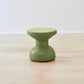 Vibrant Kanju Wiid Painted African Slim Cork Stool in a refreshing green shade, marrying eco-friendly materials with sleek design. This stool's slender silhouette and lively color make it a perfect addition to any space seeking a pop of natural vibrancy coupled with modern, sustainable craftsmanship