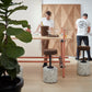 Contemporary work area elegantly styled with Kanju's Wiid Cork and Concrete Swivel Barstool in Terrazzo and Dark Cork, complemented by Wiid cork panels on the walls. This setup showcases a harmonious blend of textures and materials, highlighting the stool's unique design and the natural aesthetic of cork. The terrazzo base adds a splash of artistic detail, creating a functional yet inspiring workspace that emphasizes sustainability and modern style.