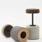 Close-up view of the bottom of Kanju's Wiid Swivel Cork and Concrete Barstool, highlighting the sturdy construction and innovative design. This image showcases the unique combination of natural cork and solid concrete, emphasizing the barstool's balance of eco-friendly materials with functional, contemporary style. The swivel mechanism is subtly integrated, offering both comfort and versatility in upscale bar settings.