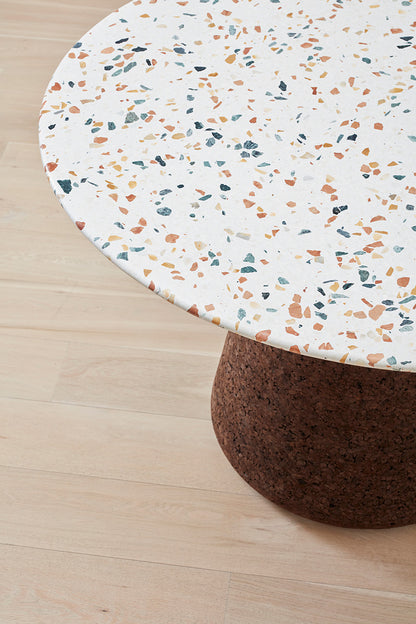 Close-up image of the exquisite terrazzo top on Kanju's Wiid Terrazzo and Cork Dining Table in Dark Cork, crafted by Wiid Design. This detailed view showcases the intricate speckled pattern and vibrant color mix, highlighting the table's luxurious and contemporary aesthetic. The terrazzo top epitomizes sustainable elegance, adding a sophisticated touch to any dining area.