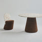 Elegant dining set from Kanju featuring the Wiid Design Terrazzo and Cork Dining Table in Dark Cork, paired with matching Wiid Design Terrazzo and Cork Dining Chairs. This sophisticated ensemble combines the unique beauty of terrazzo with the natural warmth of dark cork, offering a stunning example of sustainable luxury and innovative design. Ideal for those who appreciate artisan craftsmanship and eco-friendly materials in their dining space.